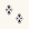 Pair of Art Deco-style stud earrings with star crystals, black enamel accents, and white gold plating on ivory background.