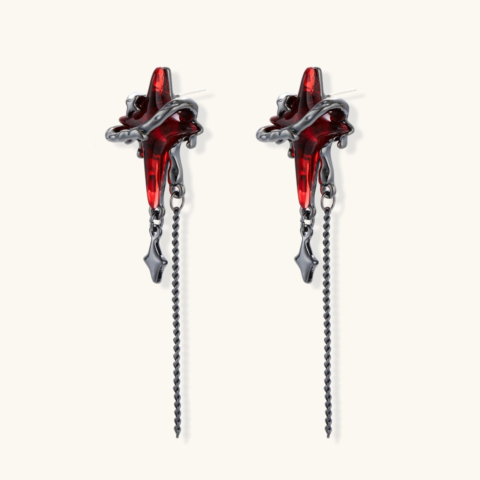 Gothic red resin dagger earrings with silver chain details and S925 posts on white background